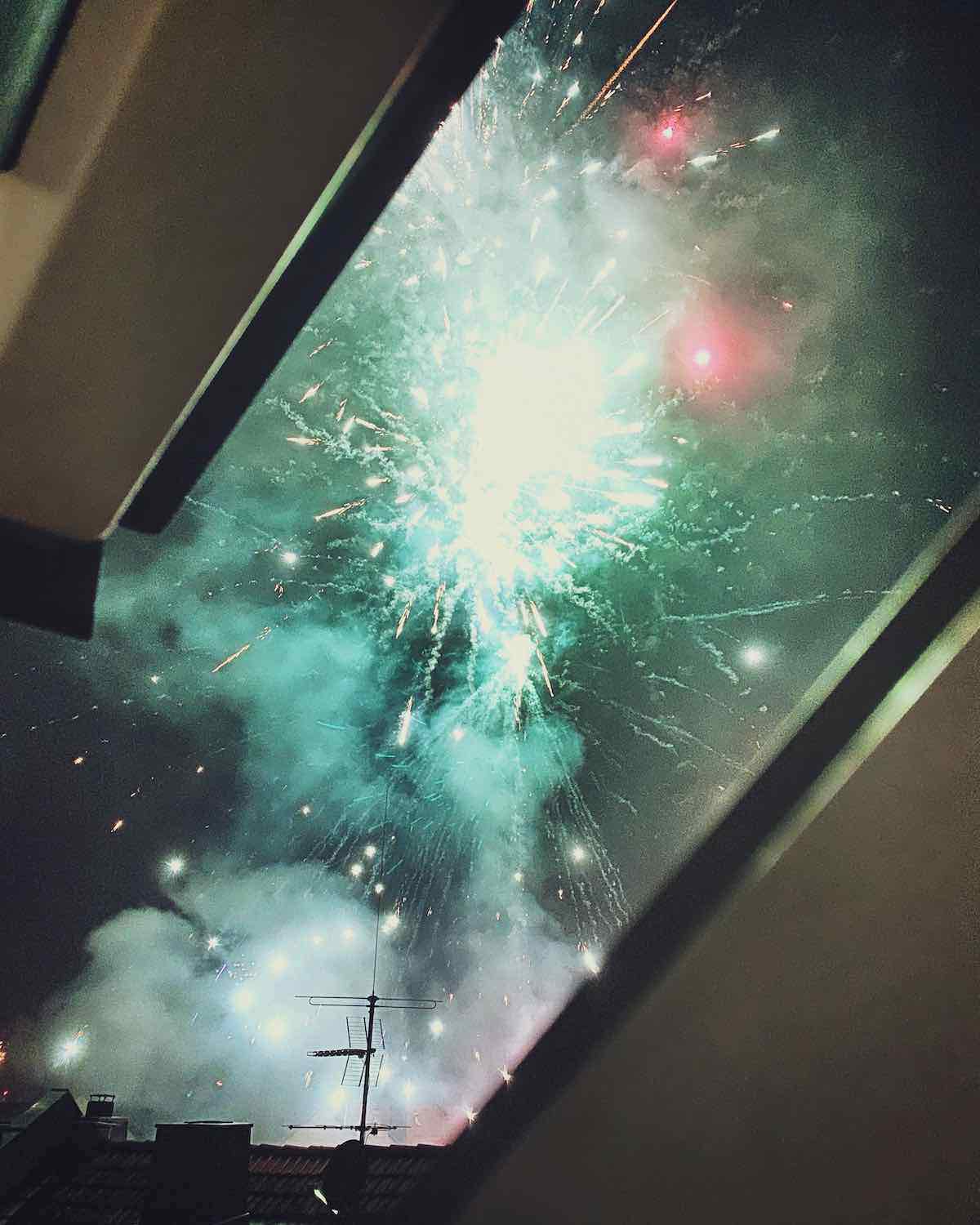 Exploding fireworks through a half opened window